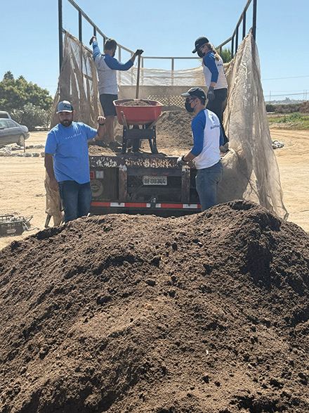 Volunteers unload soil for Garden Towers