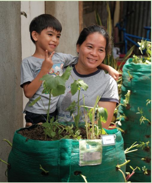A mother and son with their thriving Garden Tower