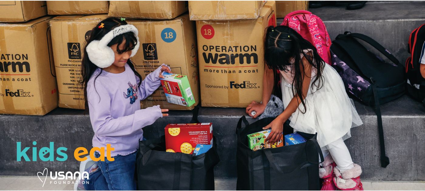 Children fill their bags at a USANA Kids Eat holiday distribution