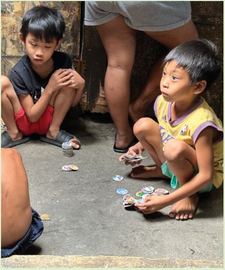 Two children sitting on a concrete floor