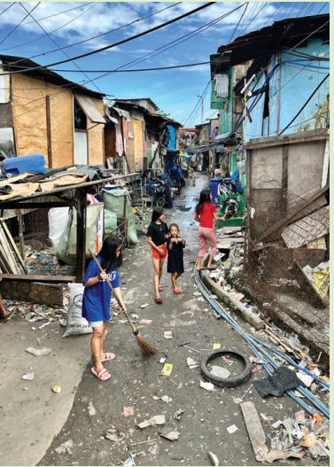 A narrow street lined with shacks
