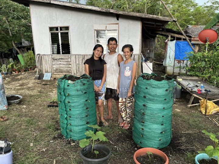 A family stands beside their Garden Towers