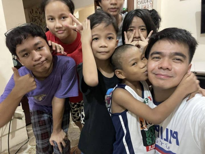 A volunteer shares a joyful moment with children in the Philippines